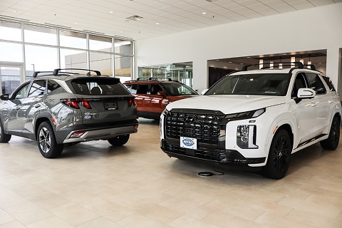 3 Hyundai SUVs parked in the Huffines Hyundai Plano showroom at the dealership in Plano, TX