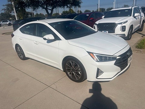 white 2020 used Hyundai Elantra sedan parked at the Huffines Hyundai Plano dealership in Plano, TX
