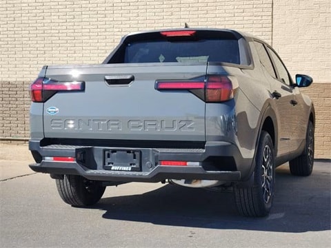  grey 2025 Hyundai Santa Cruz truck parked at the Huffines Hyundai Plano dealership in Plano, TX