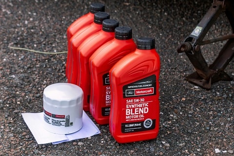 bottles of oil and an oil filter on the ground at the Huffines Hyundai Plano service center in plano, tx