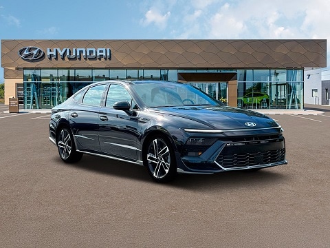black 2025 Hyundai Sonata sedan parked at the Huffines Hyundai Plano dealership in Plano, TX
