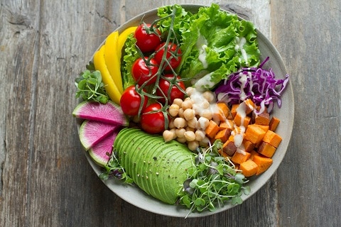 a bowl of fresh fruits and vegetables at a vegan restaurant in Plano, TX