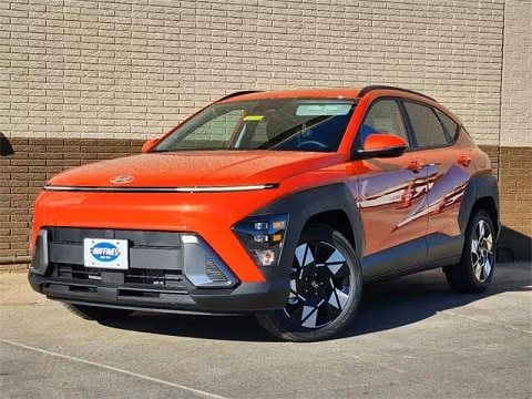 orange 2025 Hyundai Kona SUV parked at the Huffines Hyundai Plano dealership in Plano, TX