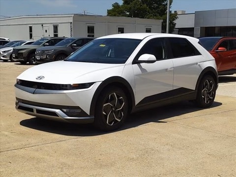 white 2024 Hyundai ioniq 5 electric vehicle parked at the Huffines Hyundai Plano dealership in Plano, TX
