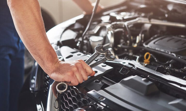 Service tech closeup under hood