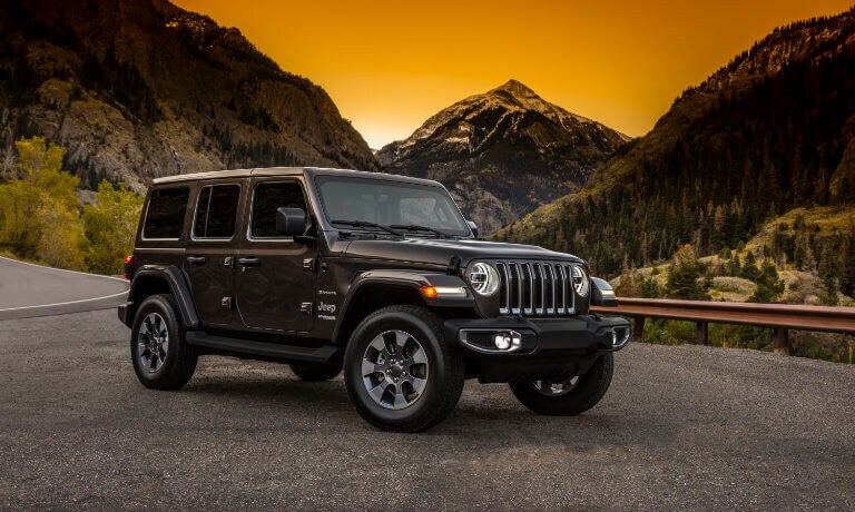 2022 Jeep Wrangler parked in front of mountains at sunset