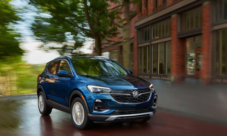 2023 Buick Encore GX driving around city curve in a blur
