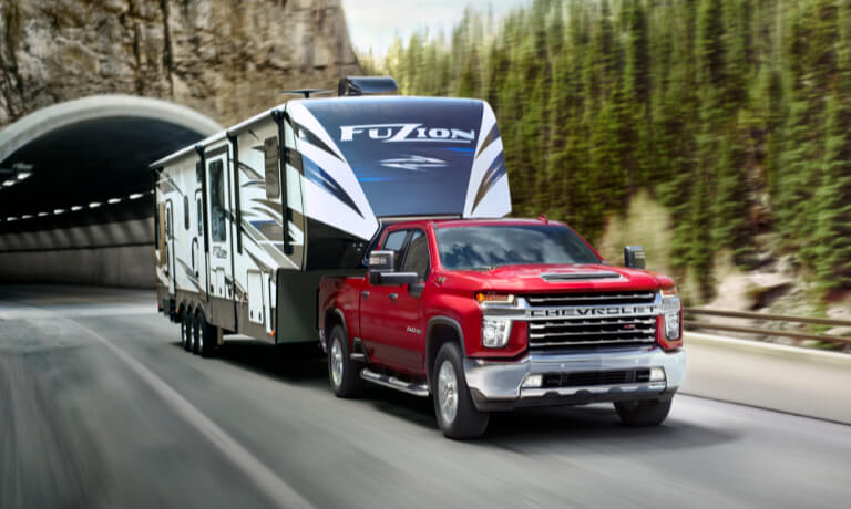 2022 Chevy Silverado 2500 HD towing an RV on the highway