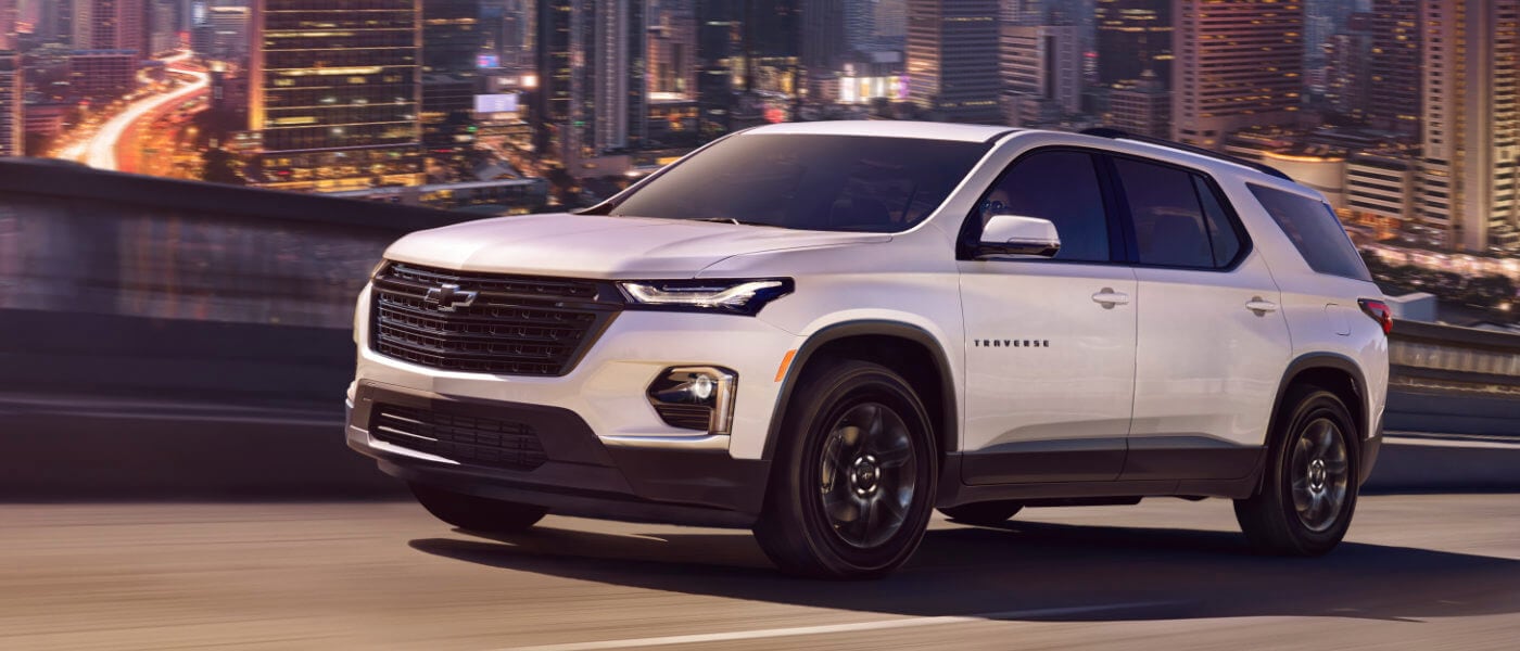 2022 Chevy Traverse driving in front of a city skyline