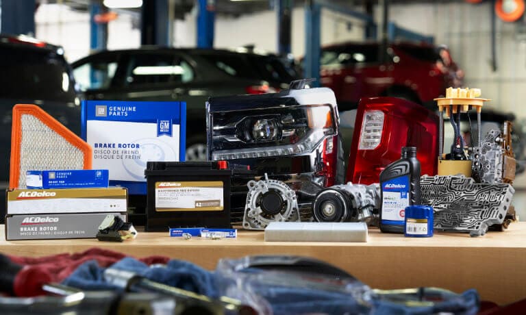 Buick and Chevrolet parts laying on a bench