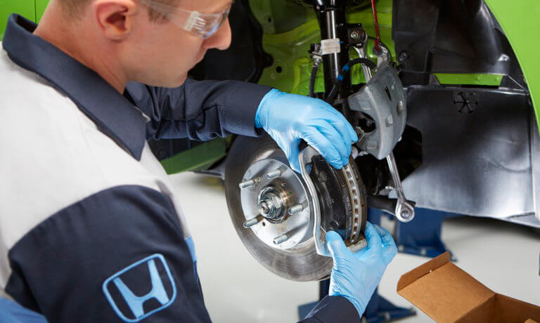 Honda Service Tech working on a rotor