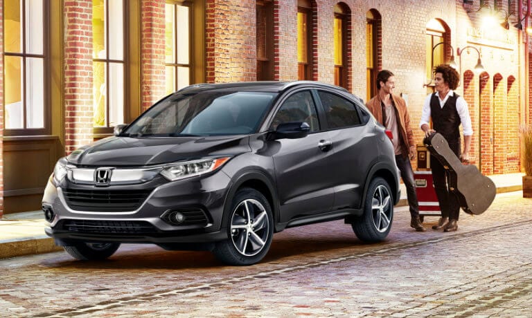 2022 Honda HR-V parked on the street with a musician