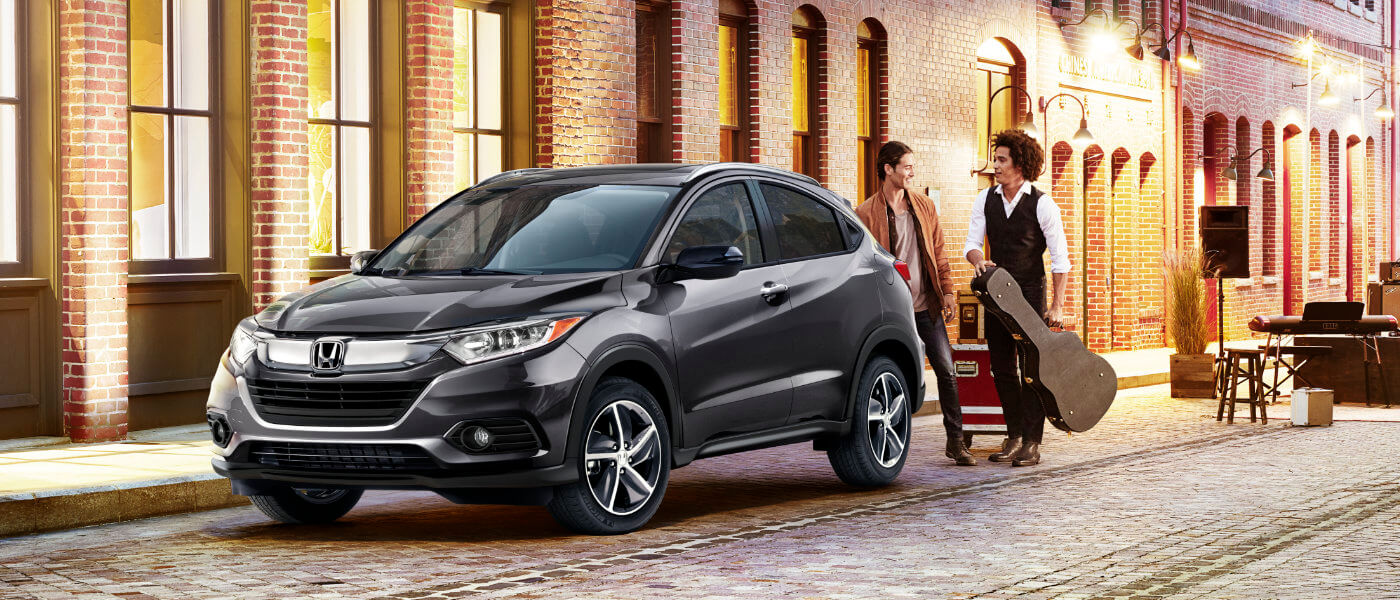 2022 Honda HR-V parked in an alley with musicians