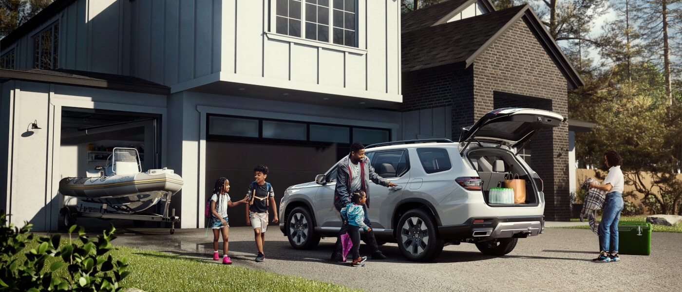 2026 Honda Pilot parked on driveway with family