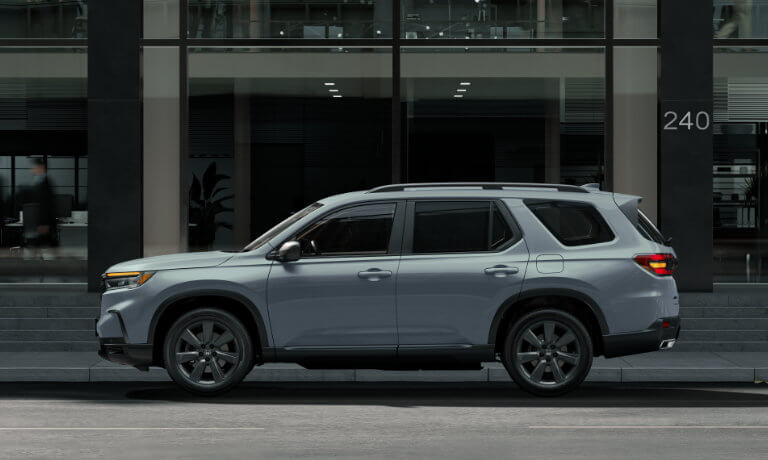 2025 Honda Pilot parked in front of glass office building