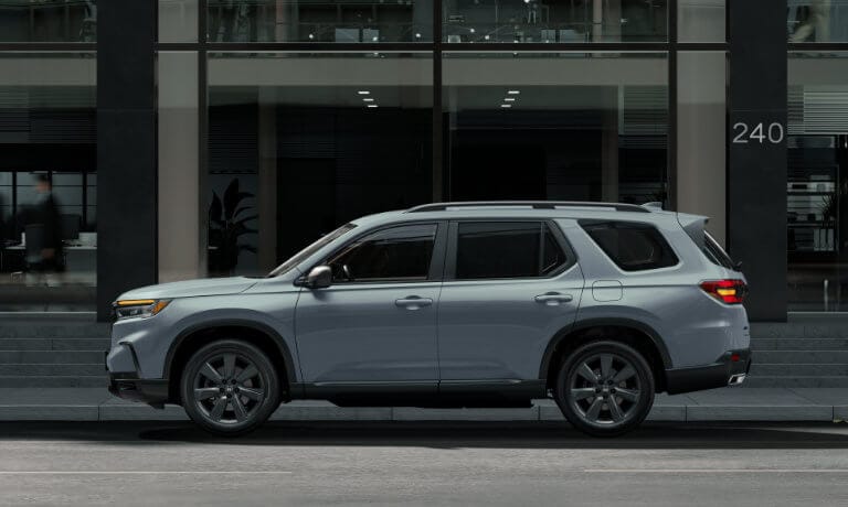 2025 Honda Pilot side in front of glass building