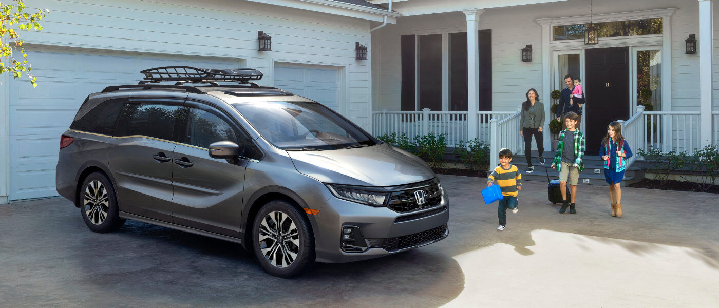 2026 Honda Odyssey parked on a driveway with family