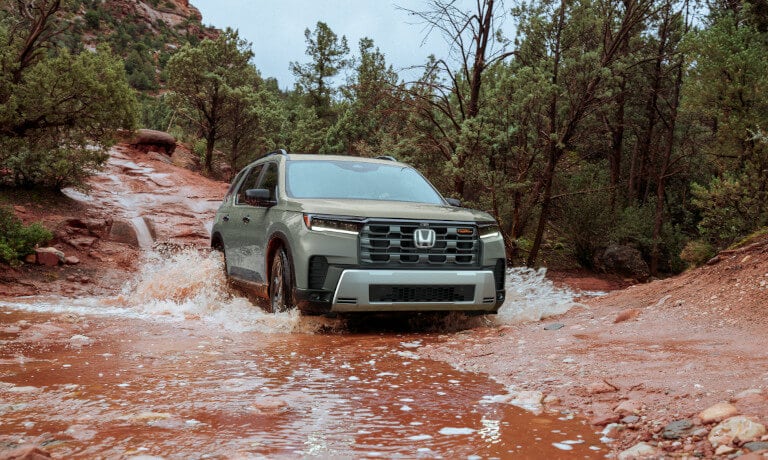 2026 Honda Pilot driving in a stream