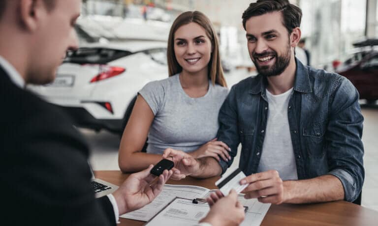 Couple at dealership making a deal