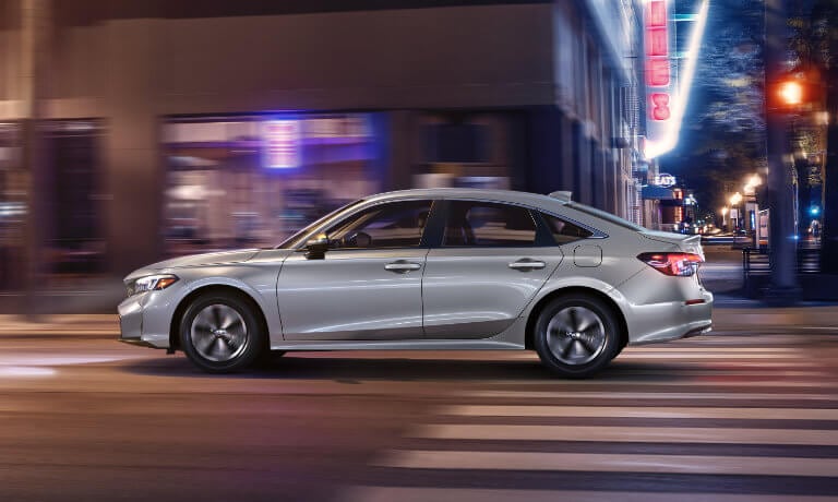 2025 Honda Civic side view in city at night