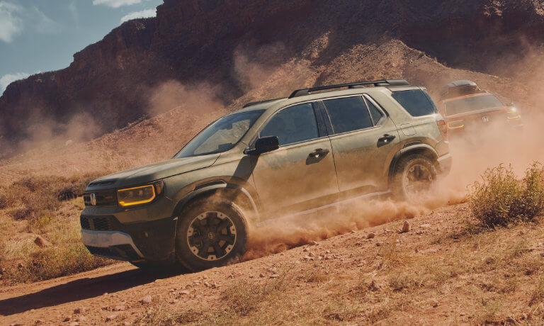2026 Honda Passport driving in dusty mountainside