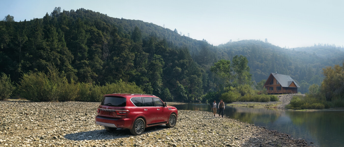2024 Nissan Armada parked by a lakeside cabin