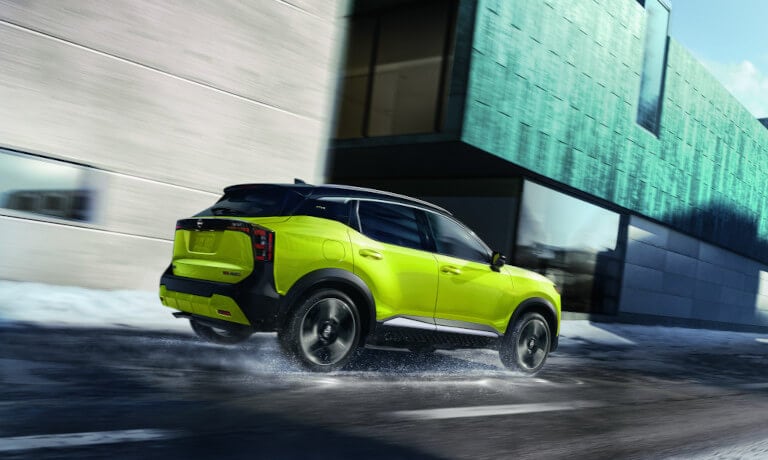 2026 Nissan Kicks driving fast on snowy road