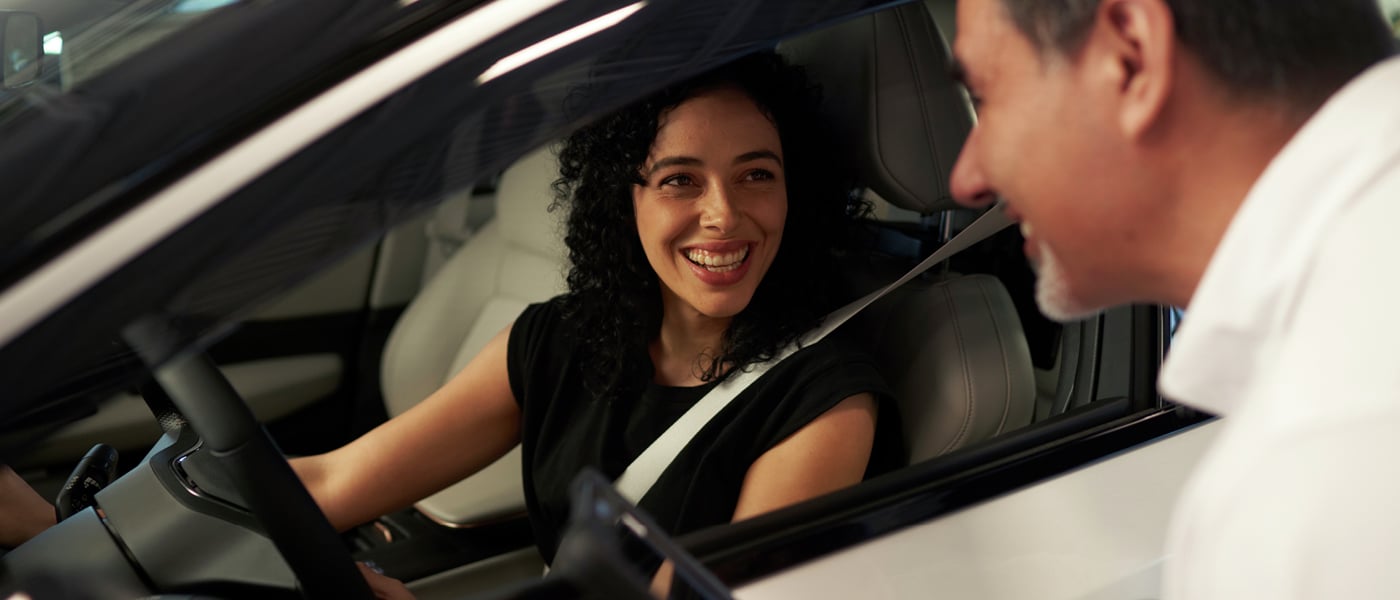 Nissan manager talking with customer in vehicle