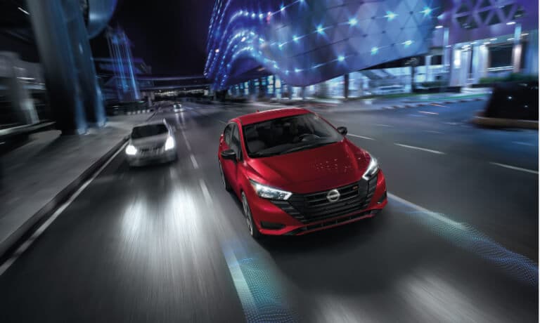2024 Nissan Versa driving at night with safety assist