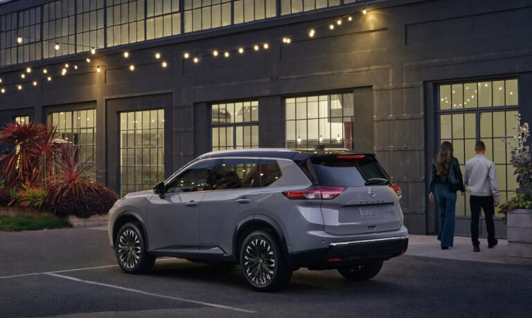 2024 Nissan Rogue parked outside a lit building