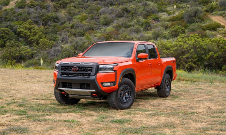 2025 Nissan Frontier parked by a grassy hill