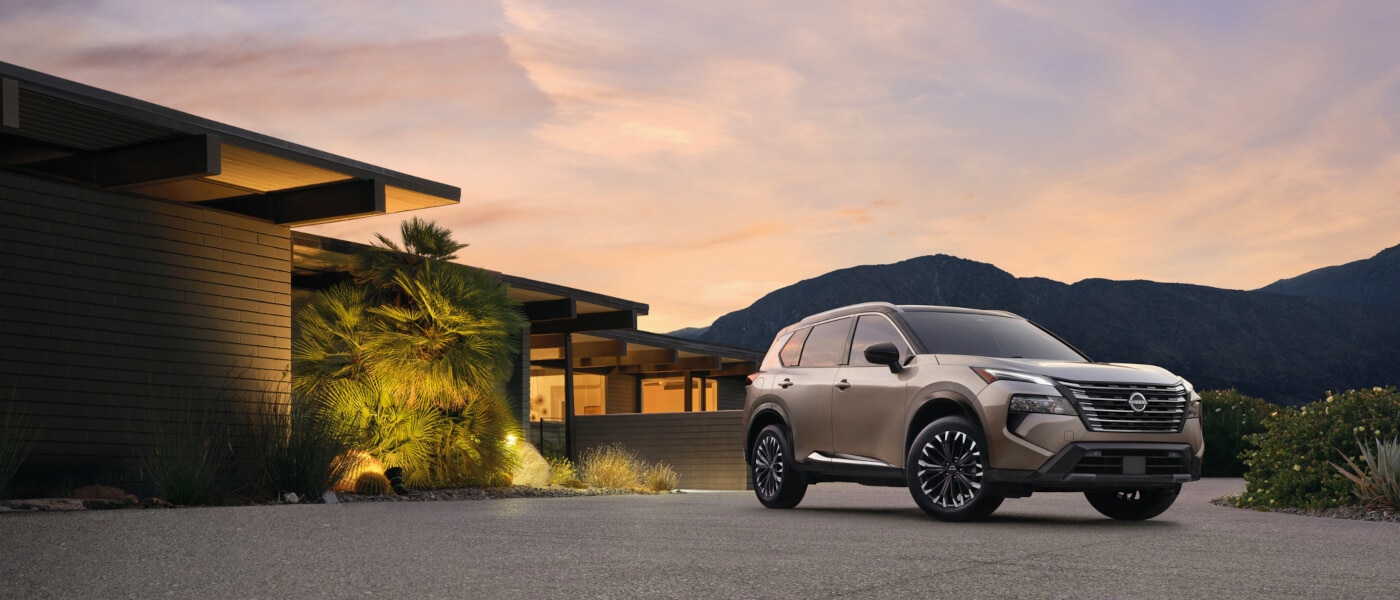 2025 Nissan Rogue parked outside a home at sunset