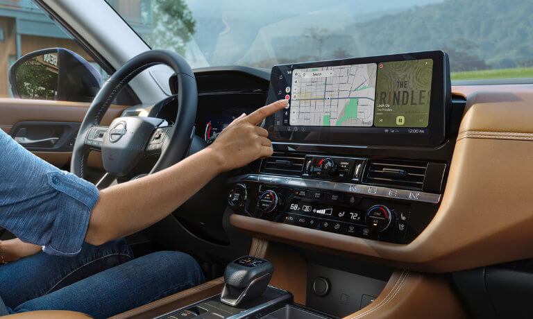 2026 Nissan Pathfinder driver using infotainment system
