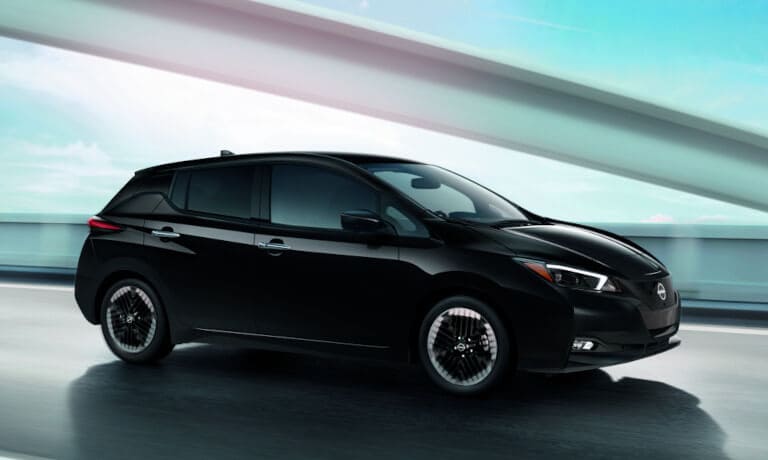 2024 Nissan LEAF driving on a blurred bridge
