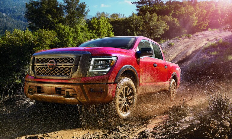 2023 Nissan TITAN driving through mud