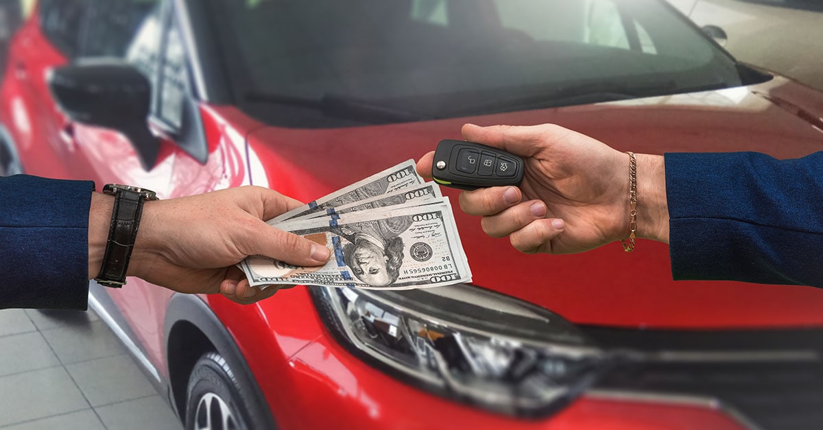 Cash and keys exchanging hands as part of Hyundai trade-in