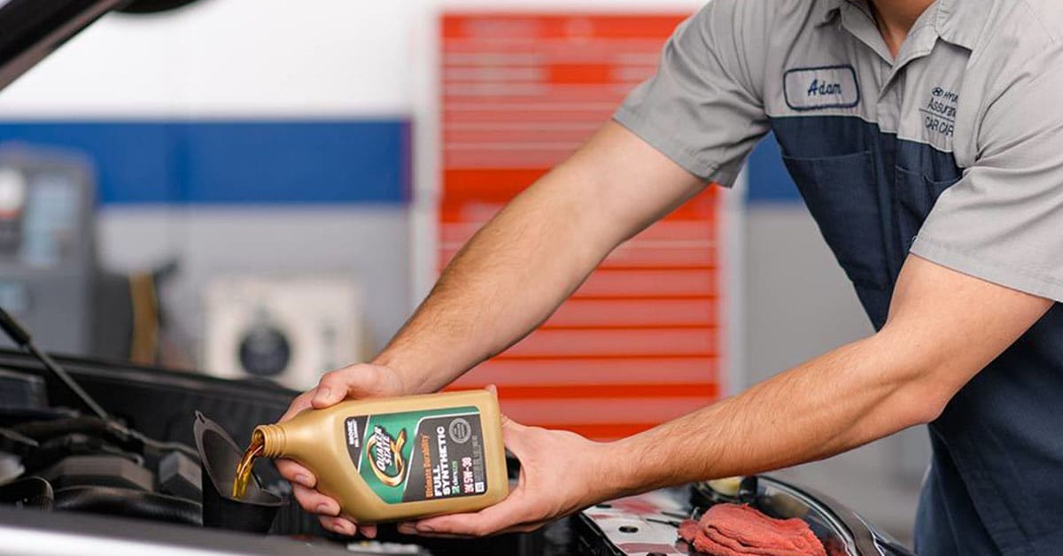 Hyundai service technician working on an oil change