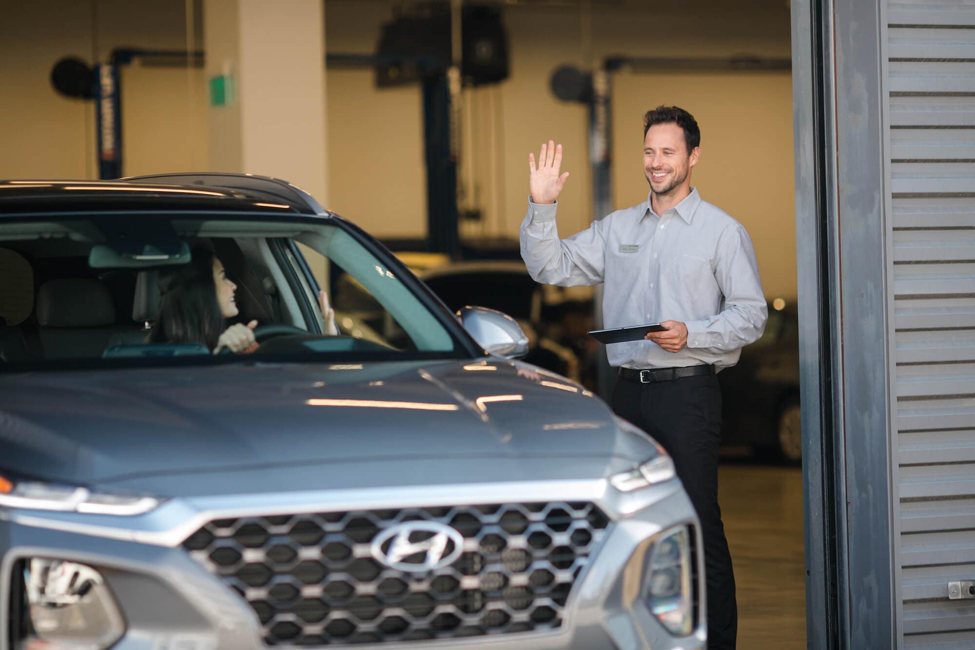 Hyundai of Central Florida - Service Advisor Waving Good-bye to Customer