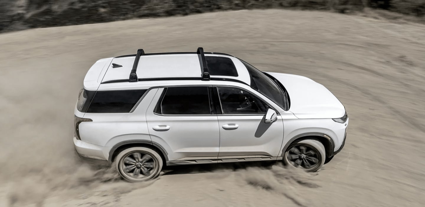 White 2023 Hyundai Palisade drifting in sand