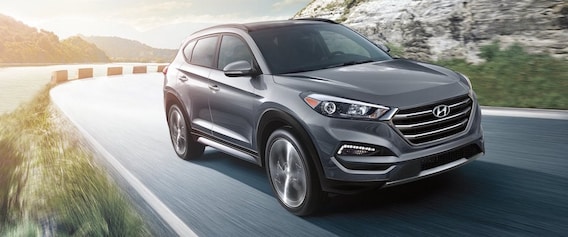 A Silver 2018 Hyundai Tuscon Driving Down An Open Road