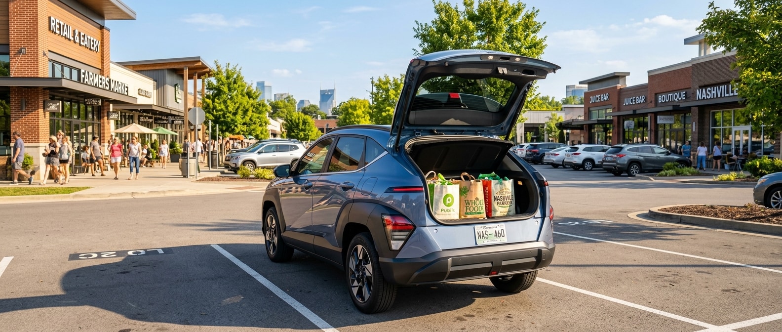 2026 Hyundai Kona with liftgate open and shopping bags loaded in cargo area at an open-air outlet center, Nashville, TN