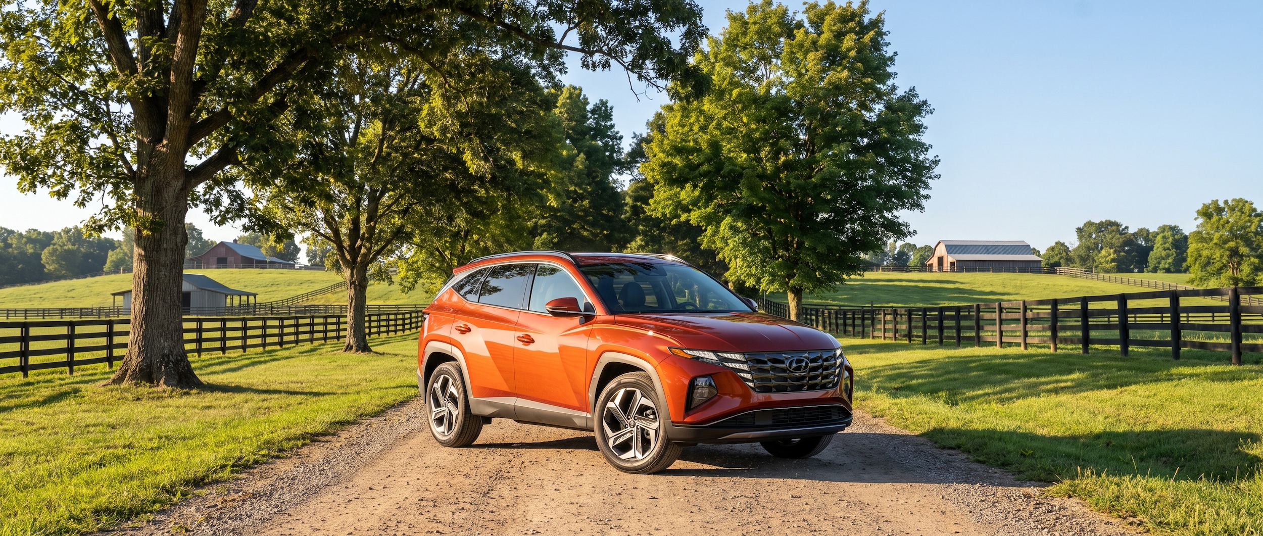 A 2026 Hyundai Tucson in a warm earth-tone color parked on a tree-lined road in rural Williamson County, Tennessee, with rolling green hills in the background on a sunny summer morning