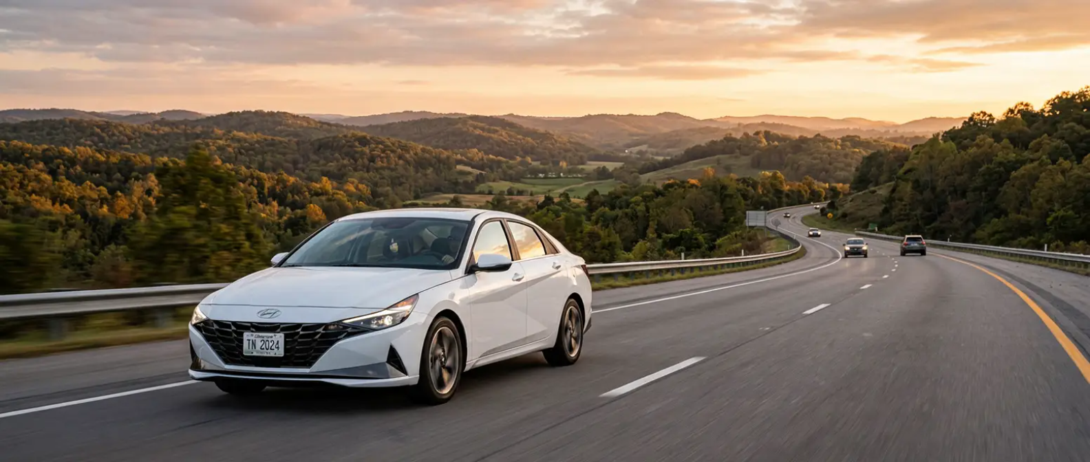 2024 Hyundai Elantra Limited driving on a Tennessee interstate highway with rolling hills at dusk