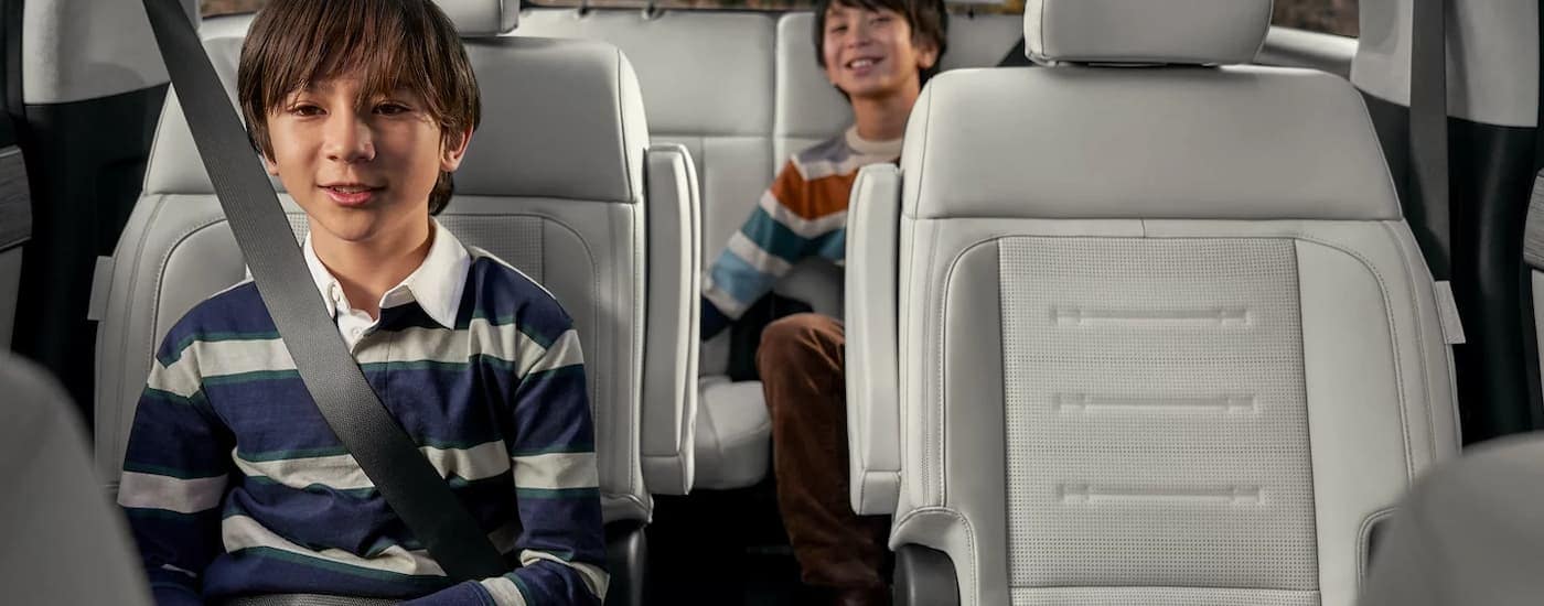 Two kids in the back seat of a 2025 Hyundai Santa Fe for sale near Weddington