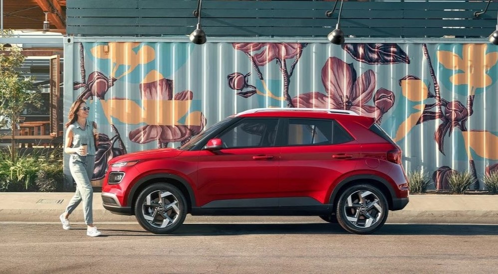 A red 2023 Hyundai Venue Limited parked in a city.
