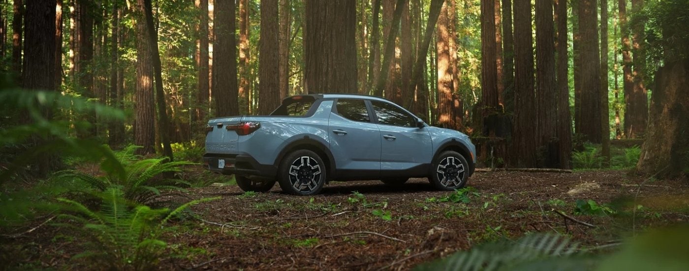 A blue 2025 Hyundai Santa Cruz is shown from the side.