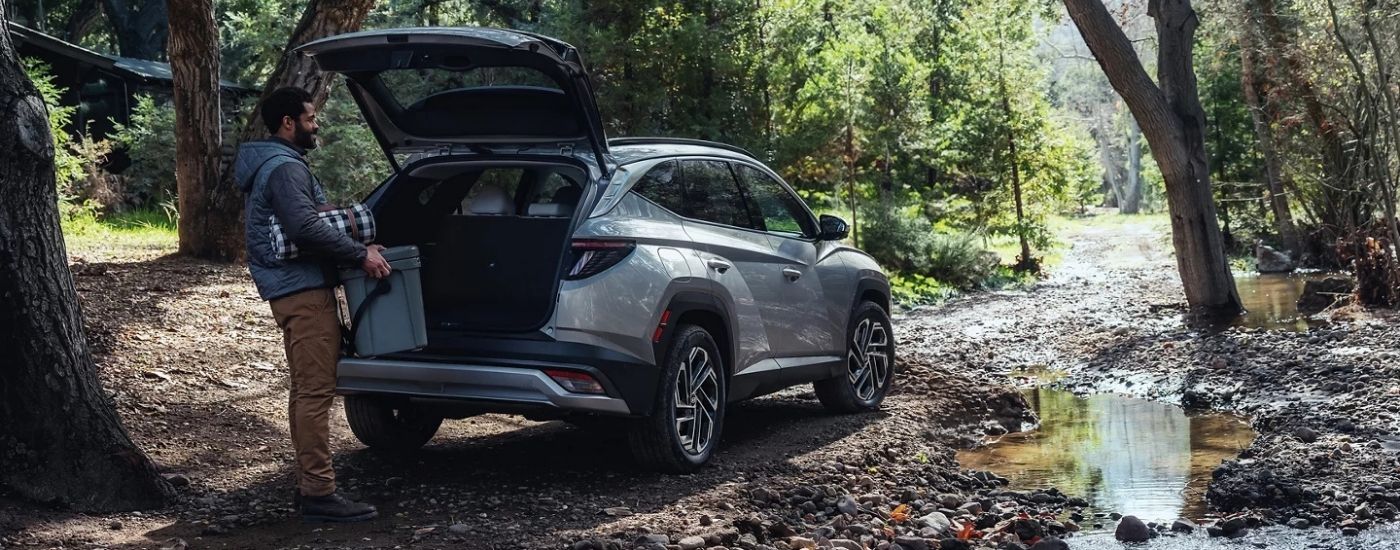 A person loading cooler in to a 2025 Hyundai Tucson PHEV Limited.