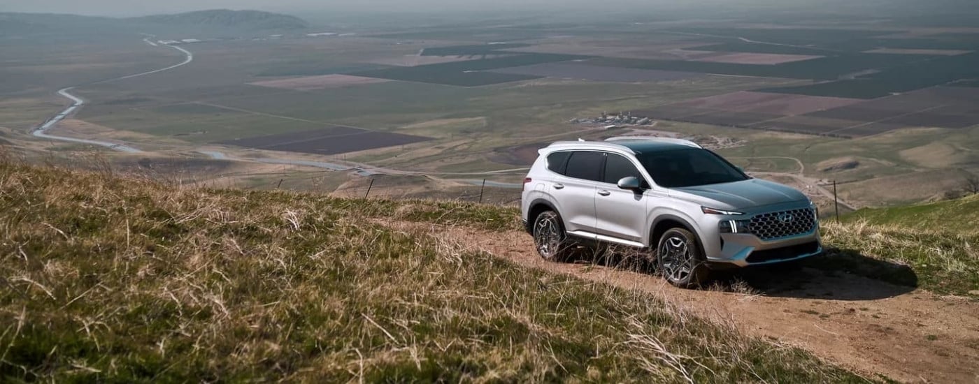 A silver 2023 Hyundai Santa Fe PHEV at an overlook after visiting a used Hyundai dealer near Indian Trail.