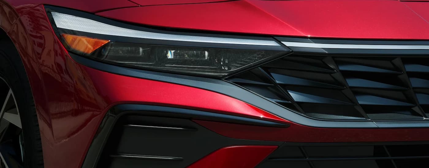 Grille and headlight on a red 2025 Hyundai Elantra for sale near Weddington