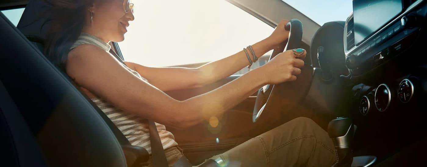 Woman test driving a 2025 Hyundai Venue for sale at a dealership